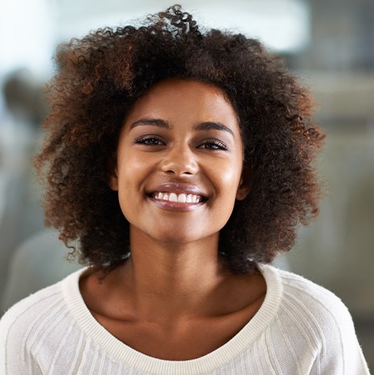 Dallas patient smiling after preventing dental emergencies