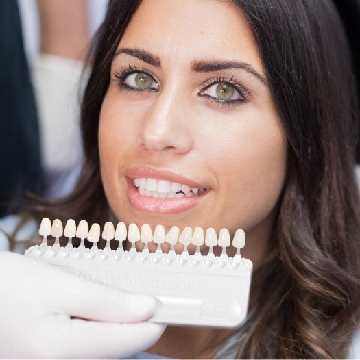 Woman with row of veneers in dental office