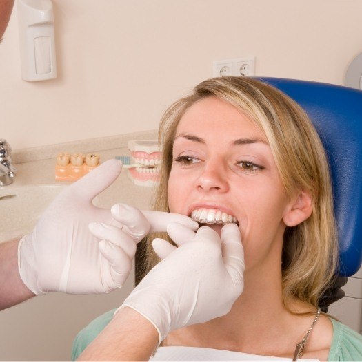 Dentist fitting a patient with Invisalign