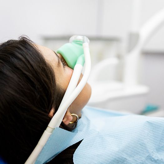 a dental patient breathing in nitrous oxide