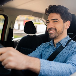 a man driving home from a dental appointment