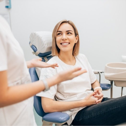 Woman smiling at her dentist during preventive dentistry checkup