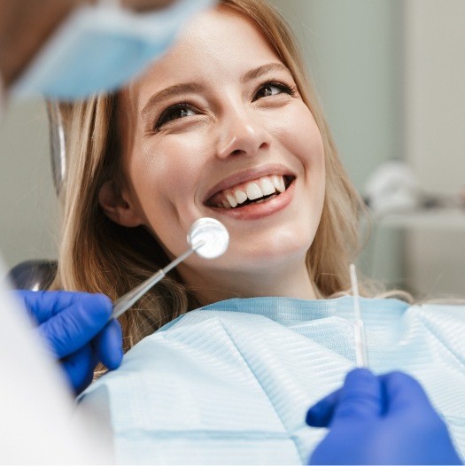 Woman smiling at her dentist before a professional dental cleaning