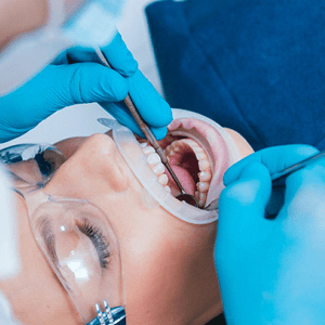 Dentist examining patient's teeth