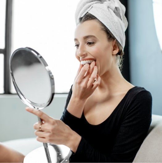 Woman using take home teeth whitening kit