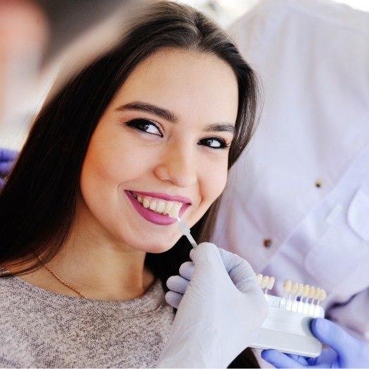 Young woman trying on dental veneers in Dallas