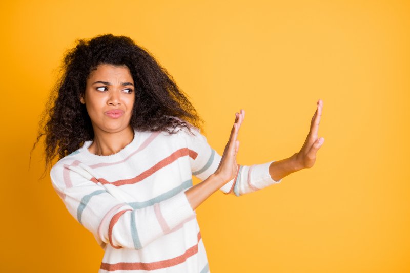 a woman putting her hands up to avoid something